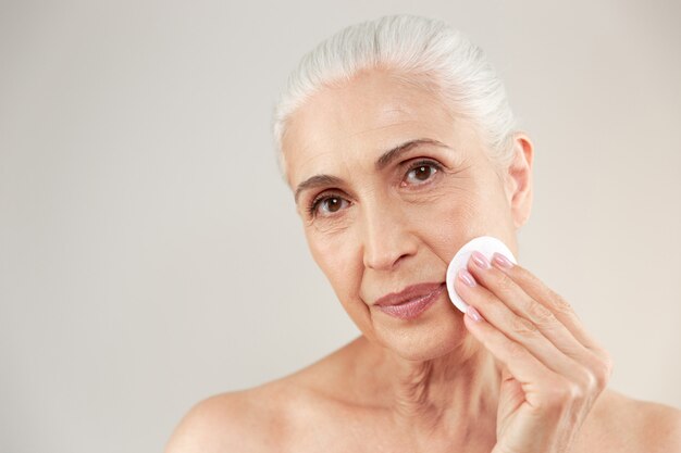 Beauty portrait of a lovely half naked elderly woman