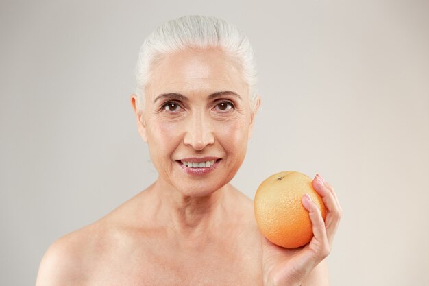 Beauty portrait of a smiling half naked elderly woman