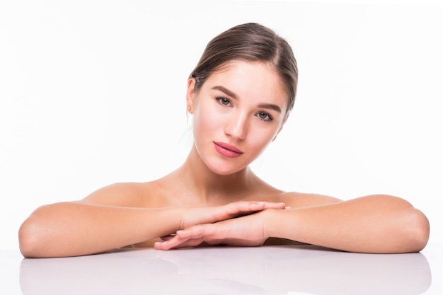 Beauty portrait of a young attractive half naked woman with perfect skin laughing and looking at camera over white wall