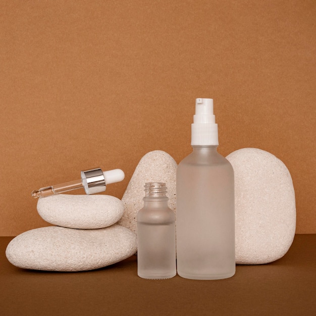 Beauty products in recipients arrangement on beige stones