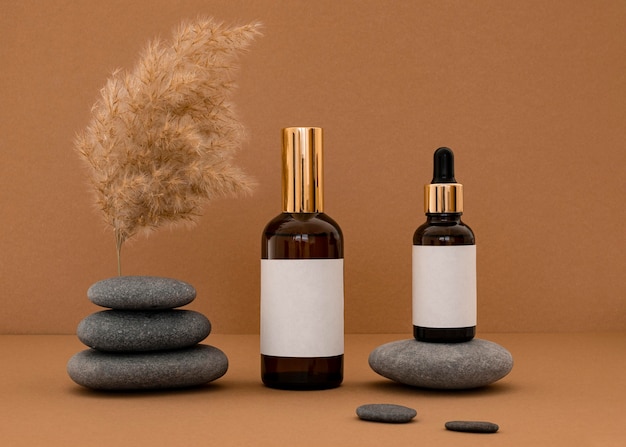 Beauty products in recipients assortment on grey stones