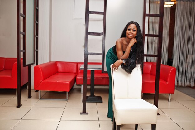 Beauty slim african american model wear on black blouse and green long legs pants posed at chinese cafe