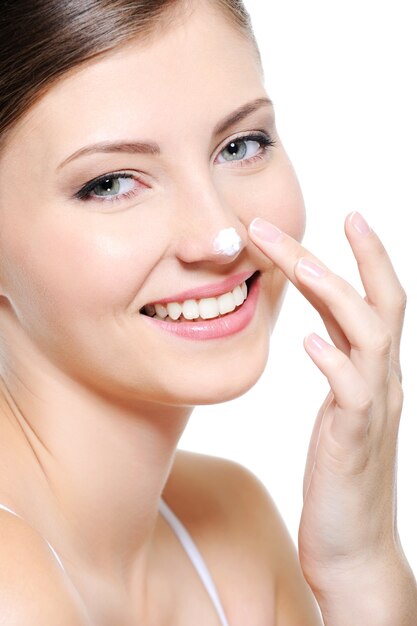 Free photo beauty smiling female face with drop of  cosmetic cream on her nose