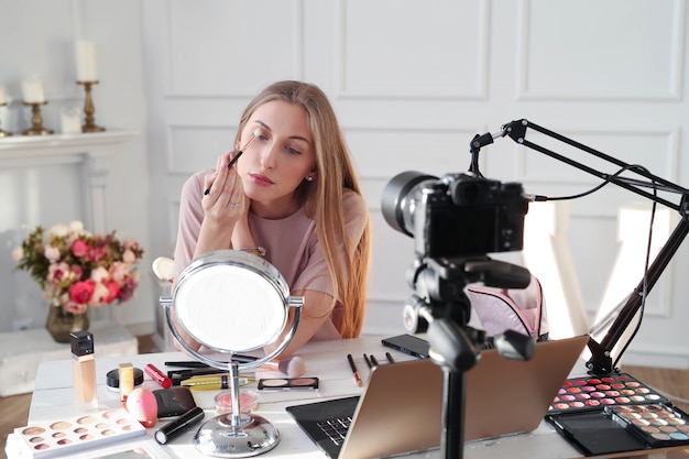 Beauty vlogger. Young woman recording a makeup tutorial