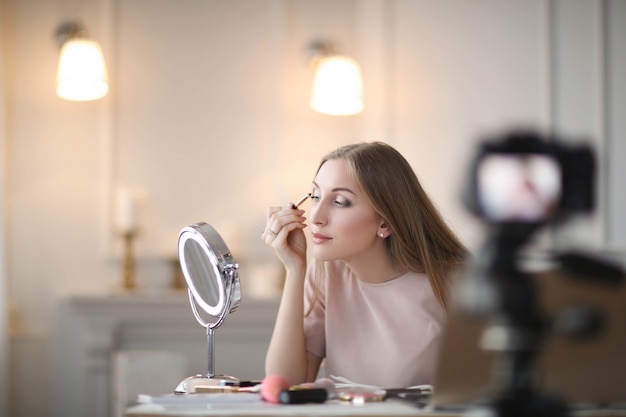 Beauty vlogger. Young woman recording a makeup tutorial