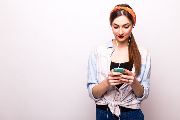 Beauty young woman using and reading a smart phone on a white