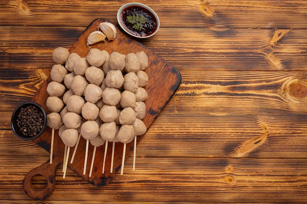 Beef ball fried on the dark wooden surface.