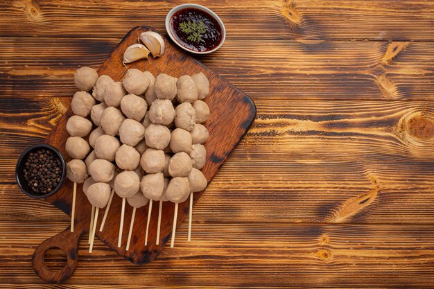 Beef ball fried on the dark wooden surface.