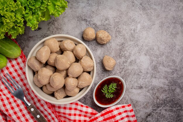 Beef ball fried on the dark wooden surface.