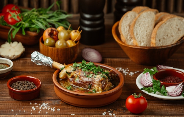 Beef bone sauteed in broth inside pottery bowl