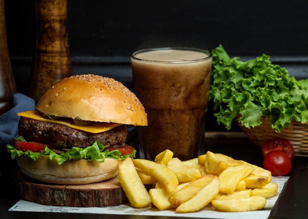 Beef burger with cheese, lettuce, tomato served with fries and coke