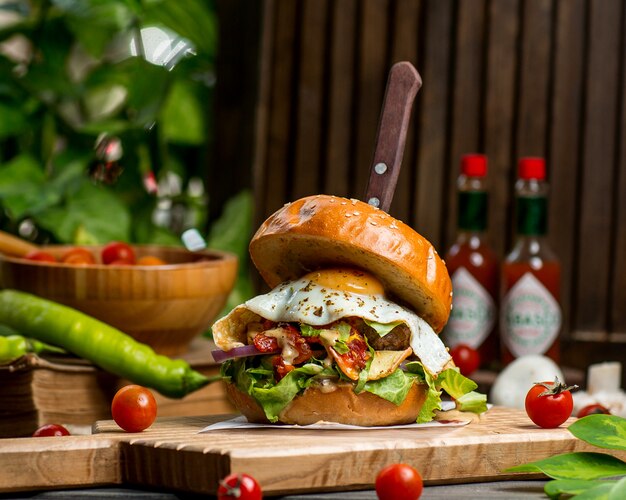 Beef burger with egg lettuce tomato and onion