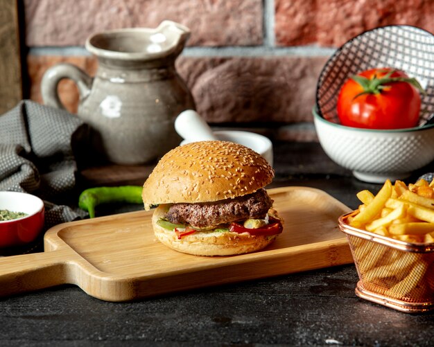 Beef burger with pickled cucumber bell peppers and lettuce
