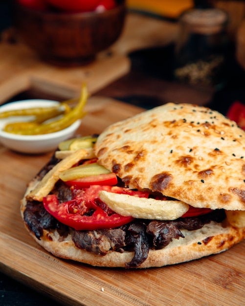 Beef doner with tomato, fries and cucumber pickles