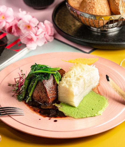 Beef steak served with sauces and herbs