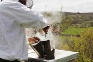 Free photo beekeeper extracting honey