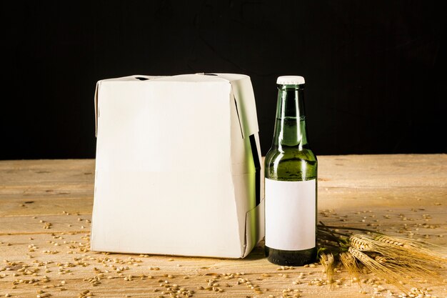 Beer bottle carton box on wooden background 