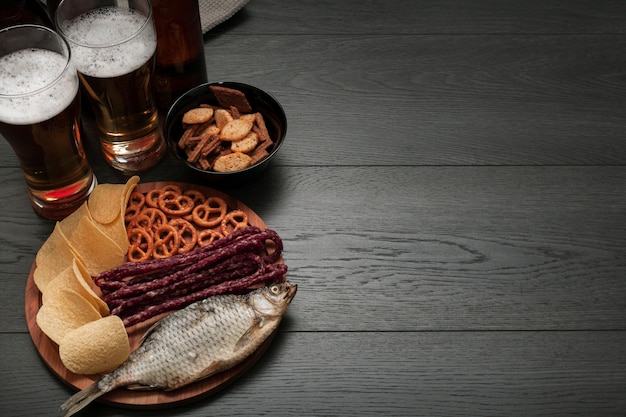Beer glasses and platter of food with copy space