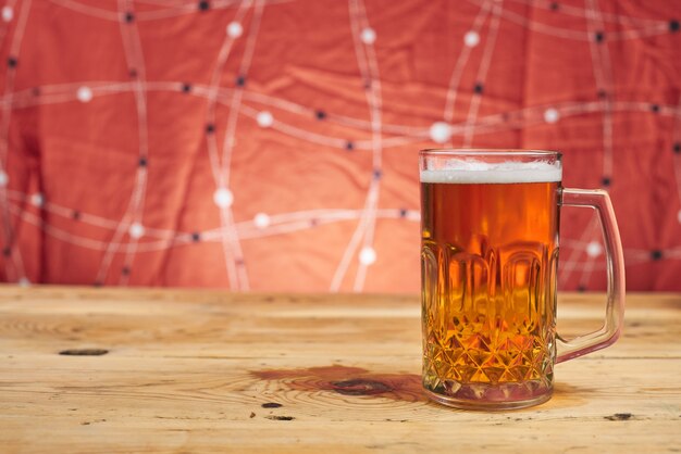 Beer inside the mug on the wooden table