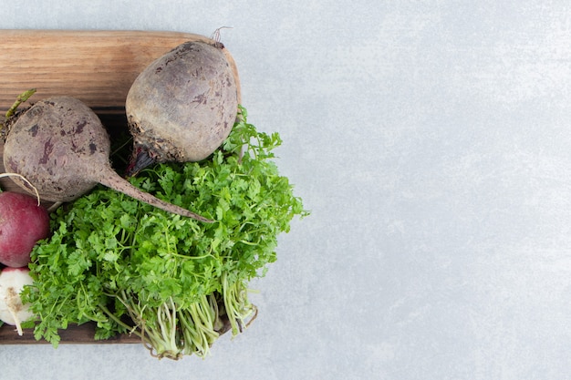 Free photo beetroot , radish and parsley on board , on the marble.