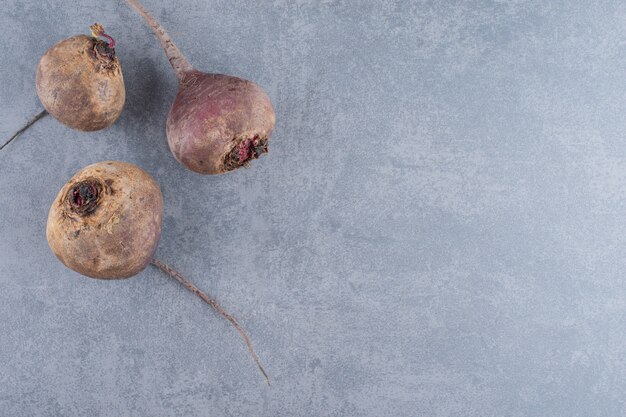 Beetroots isolated on the blue concrete surface