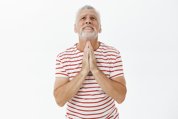 Begging elderly man pleading God, supplicating