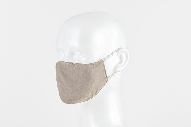 Beige fabric face mask on a dummy head