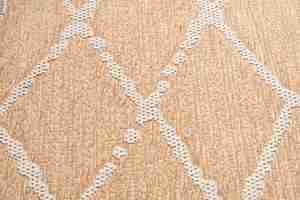 Free photo beige lintfree cotton rug with geometric knitted vertical rhombus ornament