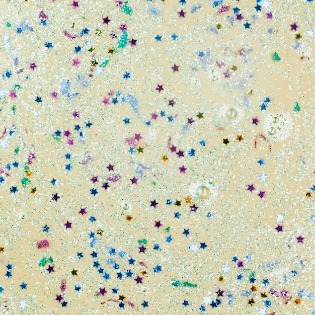 Free photo beige liquid with blobs and ornamental stars