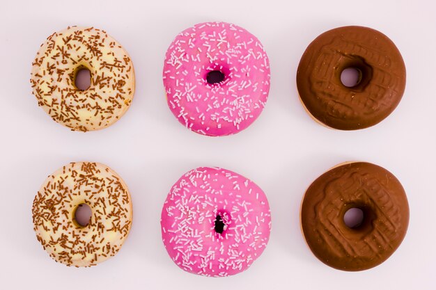 Beige; pink and brown donut on white background