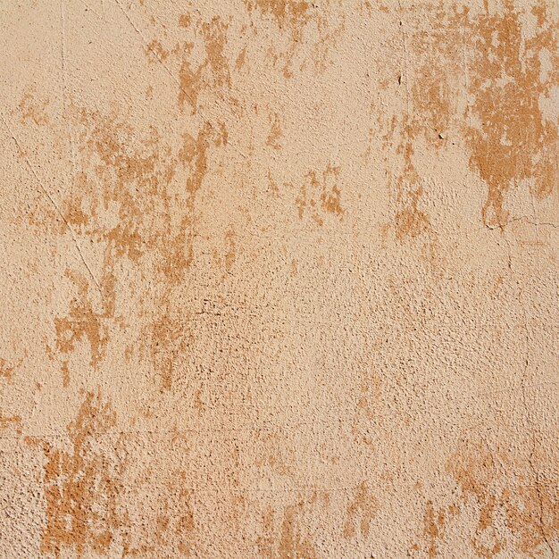 Beige plaster wall with peeling paint