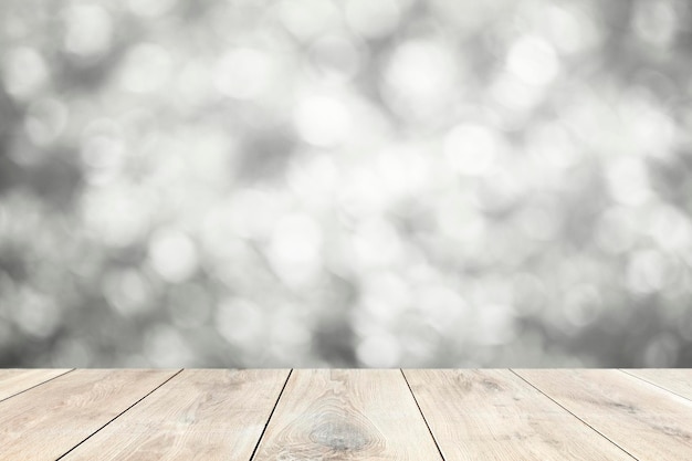 Beige wooden planks with blurry gray lights background