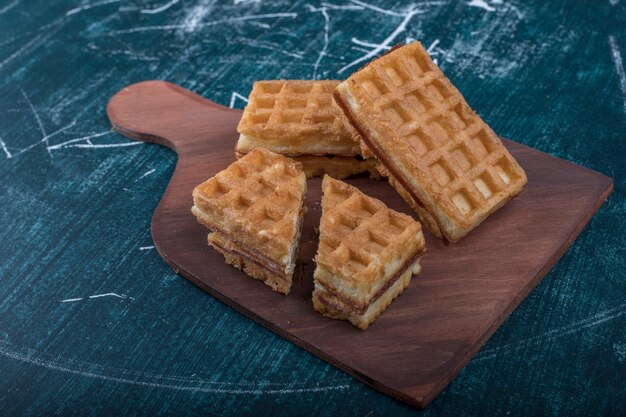 Belgian waffle slices on a wooden board