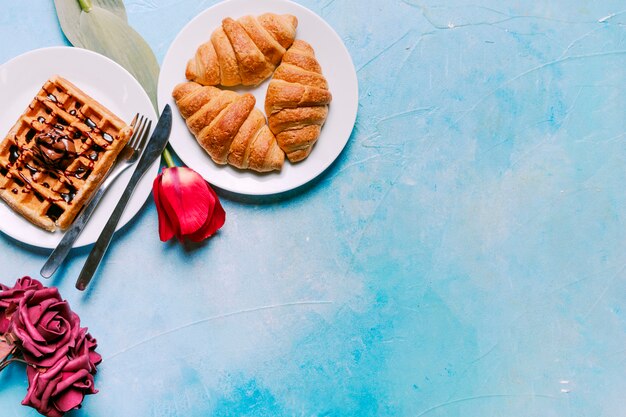 Belgian waffle with croissants and flowers 