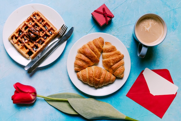 Belgian waffle with croissants on plate