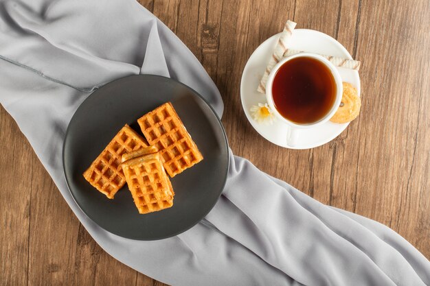 Belgian waffles and a cup of tea. top view