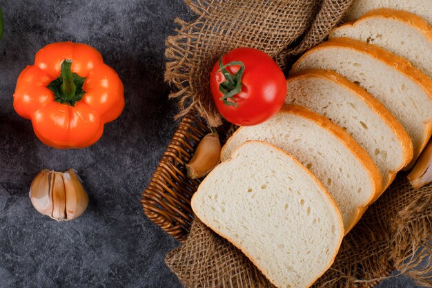 Bell peppers, garlic and tomatoes with bread slices. Top view.