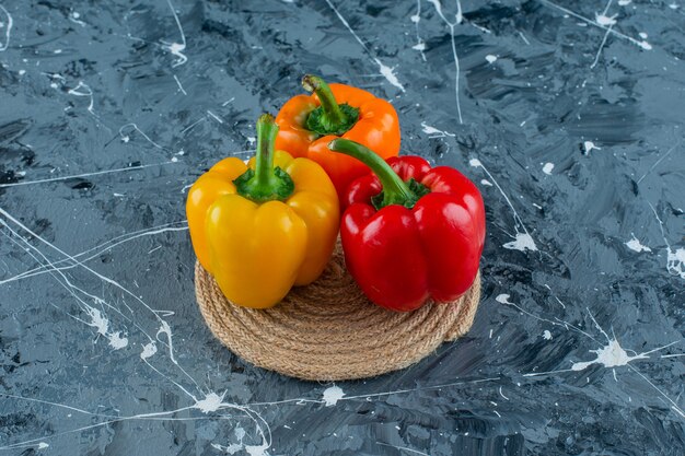 Bell peppers on a trivet, on the marble background. 