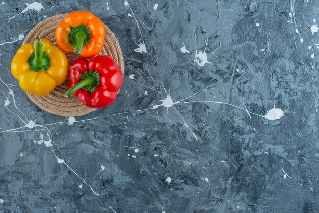 Bell peppers on a trivet, on the marble background. 