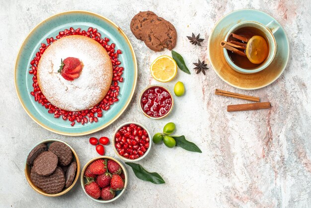 berries and cookies a cup of tea with lemon and cinnamon cookies the cake jam