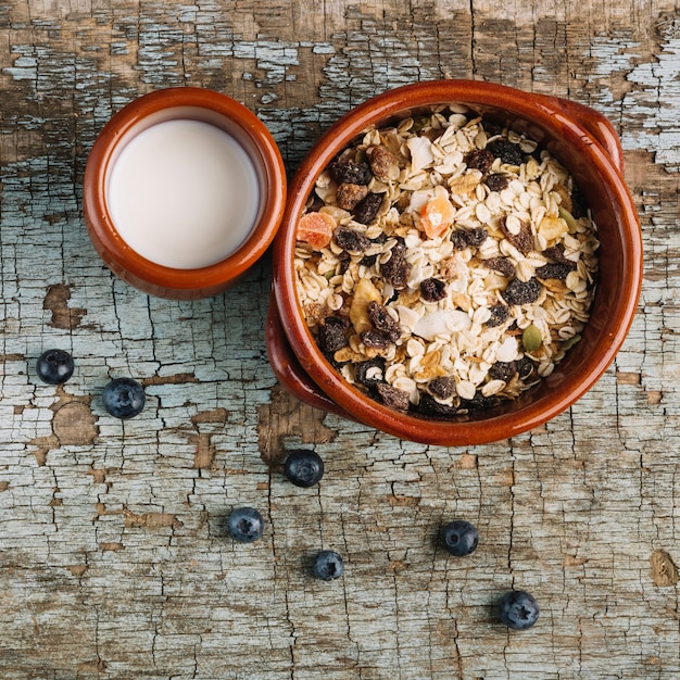 Berries near muesli and milk