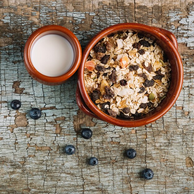 Berries near muesli and milk