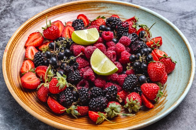 Berries plate with raspberry blackberry strawberry and black currant