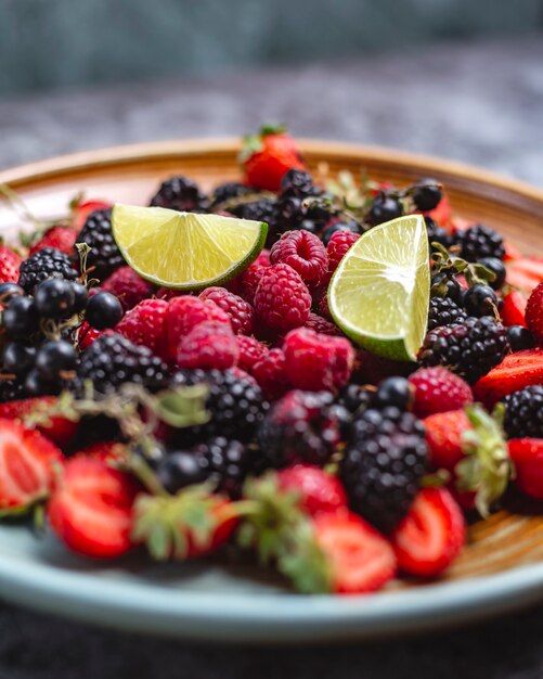 Berries plate with raspberry, blackberry, strawberry and black currant