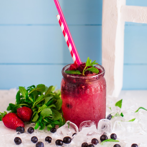 Free photo berry cocktail with strawberry, raspberry and ice in glass jar