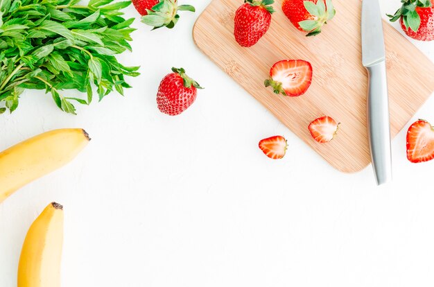 Berry fruits slicing on cut board