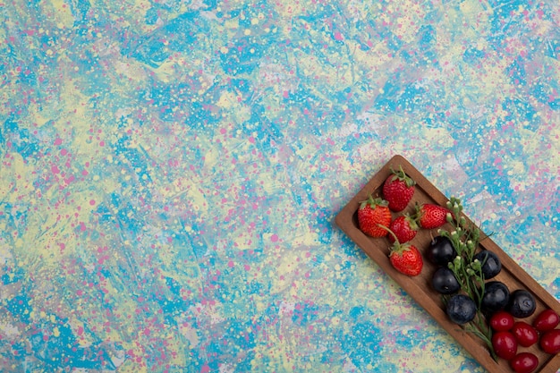 Berry mix on a wooden platter isolated in the corner