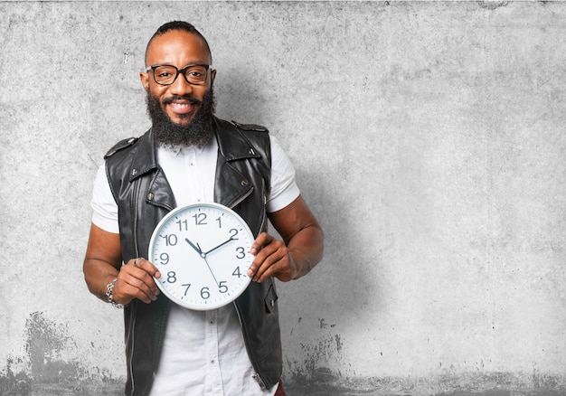 Bespectacled man holding a clock