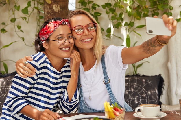 Free photo best female friends have fun together and takes selfie photo