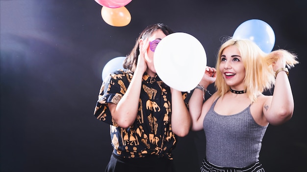 Best friends celebrating with balloons